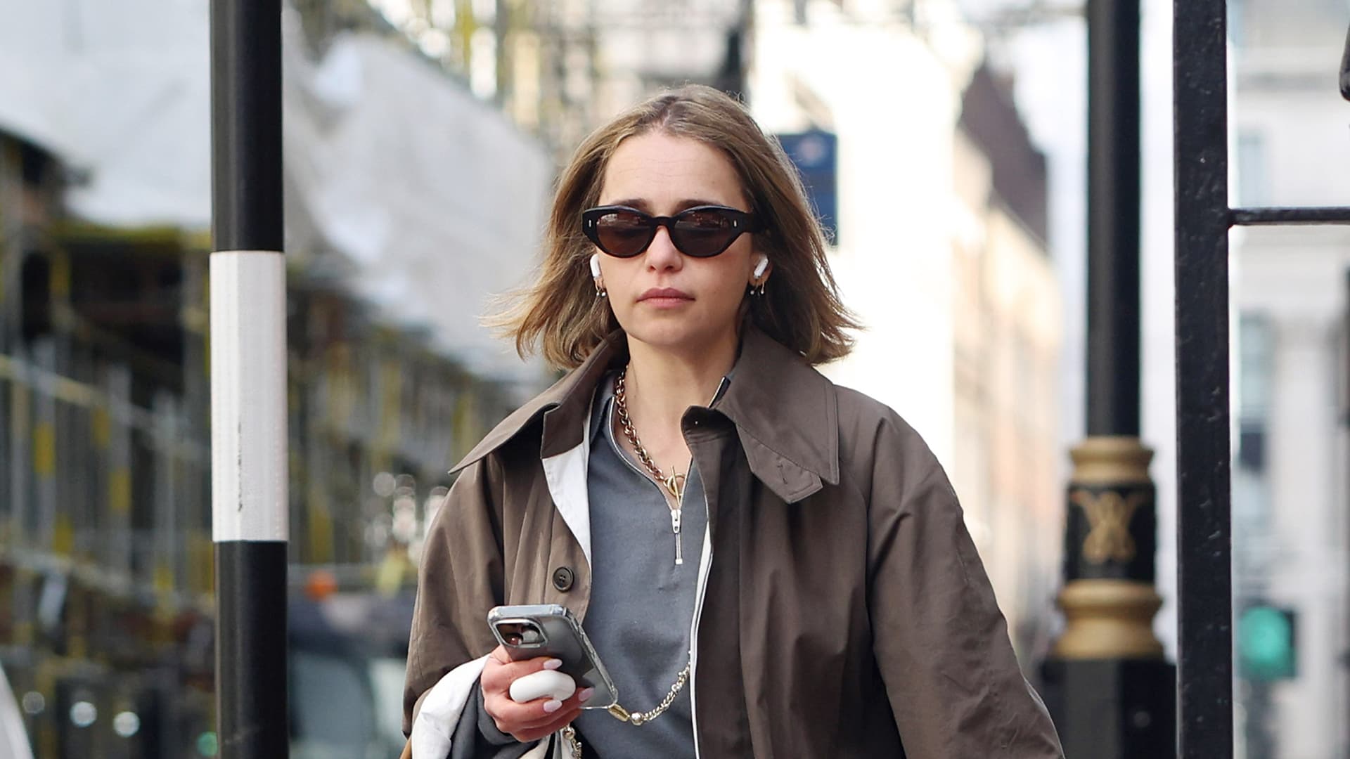 The quarter-zip and white jeans combo defining spring style now
