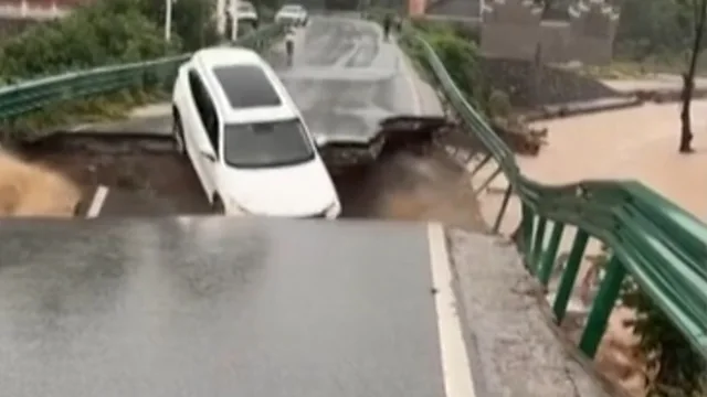 Car falls from collapsed China bridge amid deadly flooding