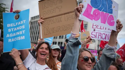Thousands gather at Belfast City Hall to protest racism after unrest