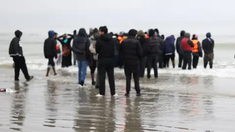 Two women die as migrant boat carrying 82 runs aground in France