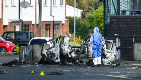 Belfast security alert continues after explosion outside Dunmurry police station