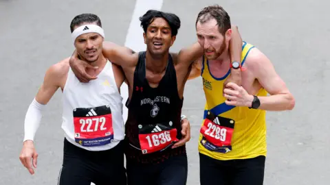 Two runners help exhausted man finish Boston Marathon together