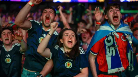 Fans gather nationwide to watch early-hours match against Haiti