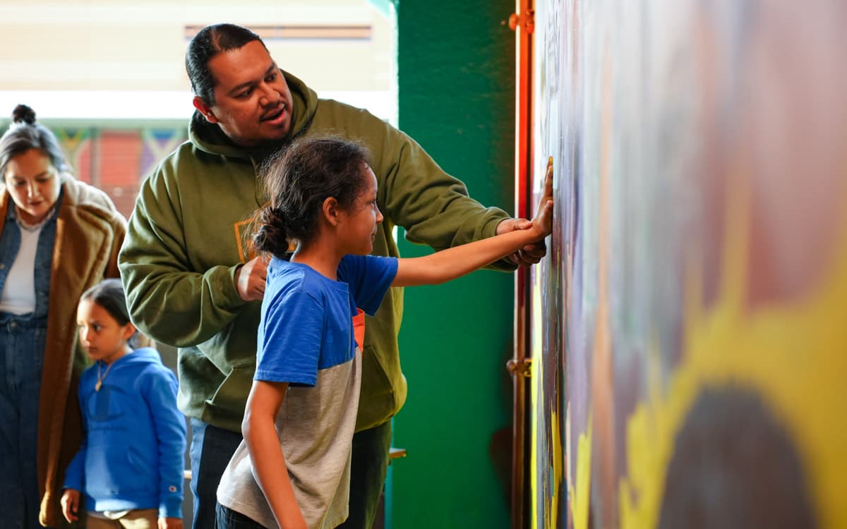 Lawrence residents add handprints to downtown mural celebrating city diversity