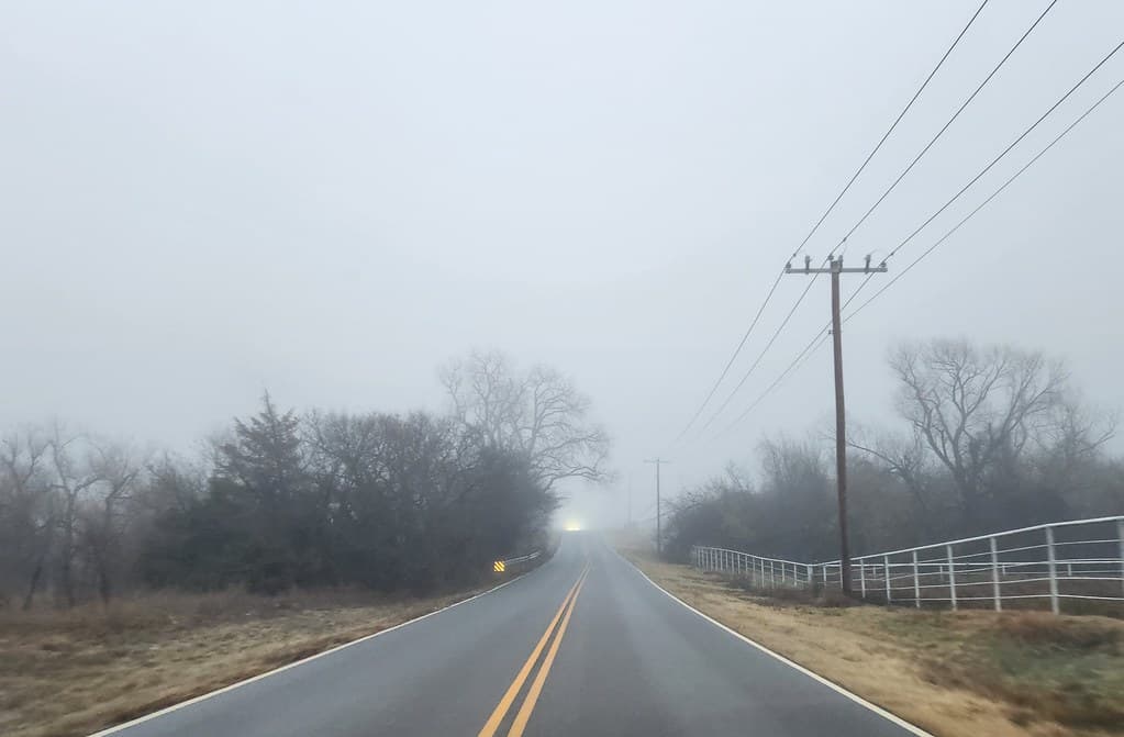 Fog Photograph Highlights Rural Road Safety and Community Connection