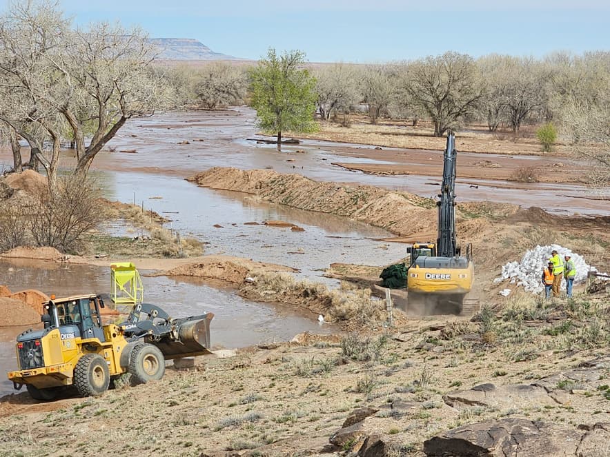 Heavy equipment arrives in Chinle near Canyon de Chelly to build berms