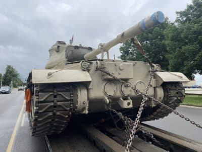 Military tank on trailer pauses in North Lawrence before Arkansas trip