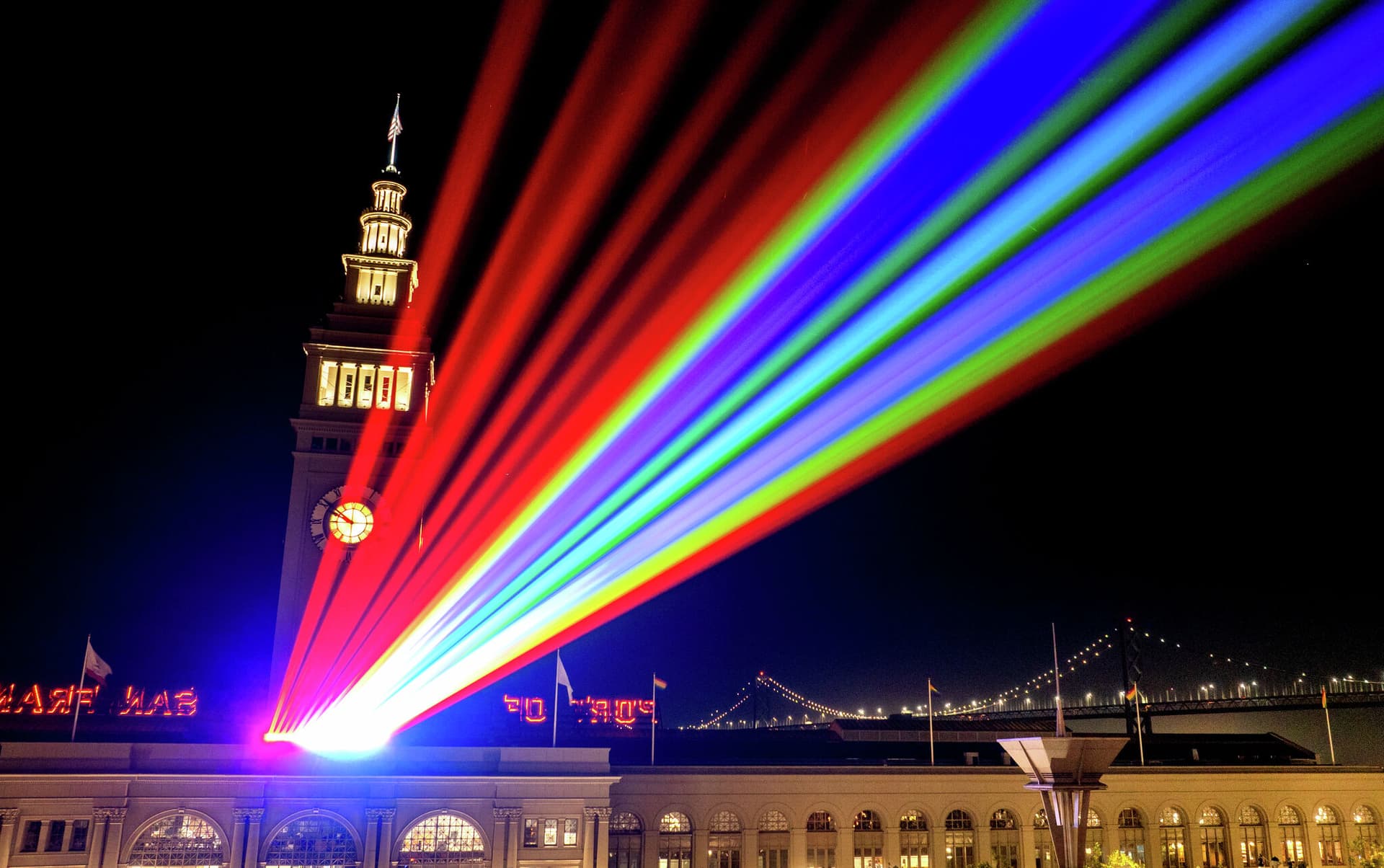 Lasers light San Francisco sky from Transamerica Pyramid to Coit Tower