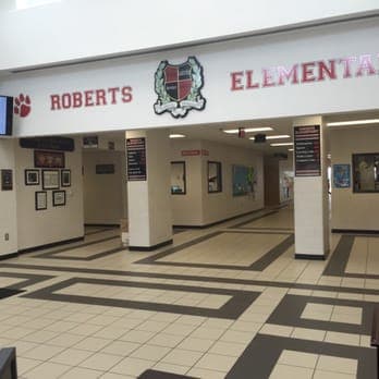 Georgia Tech’s Jordan Allen reads with students at Roberts Elementary