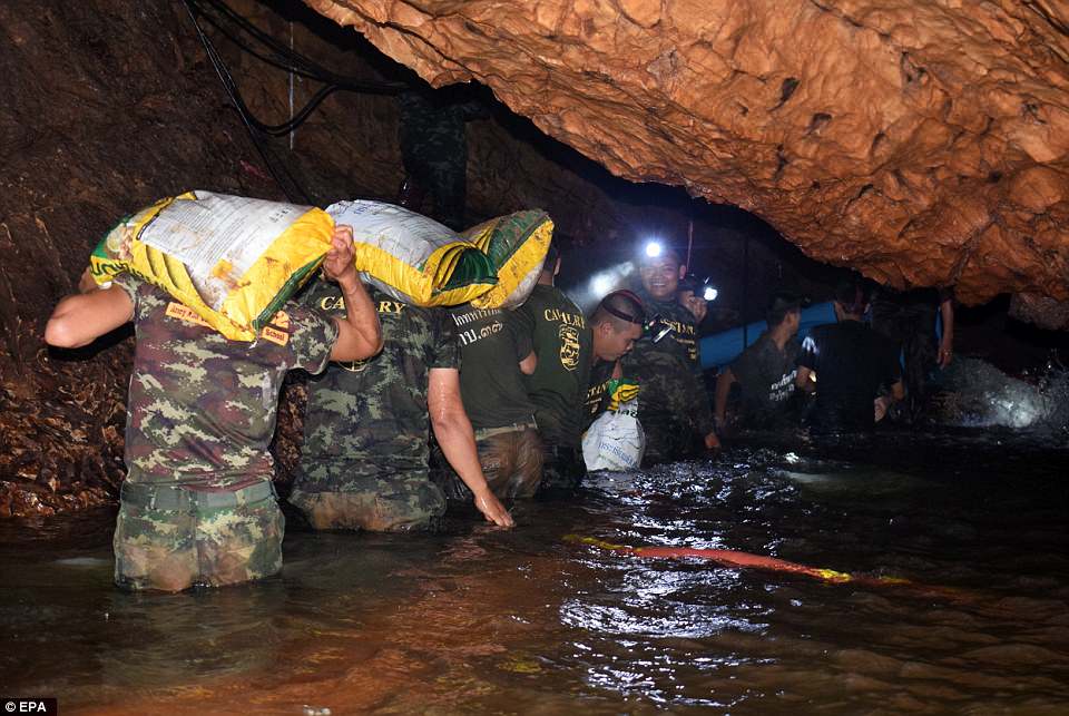 Laos rescuers race to reach seven trapped in flooded cave system