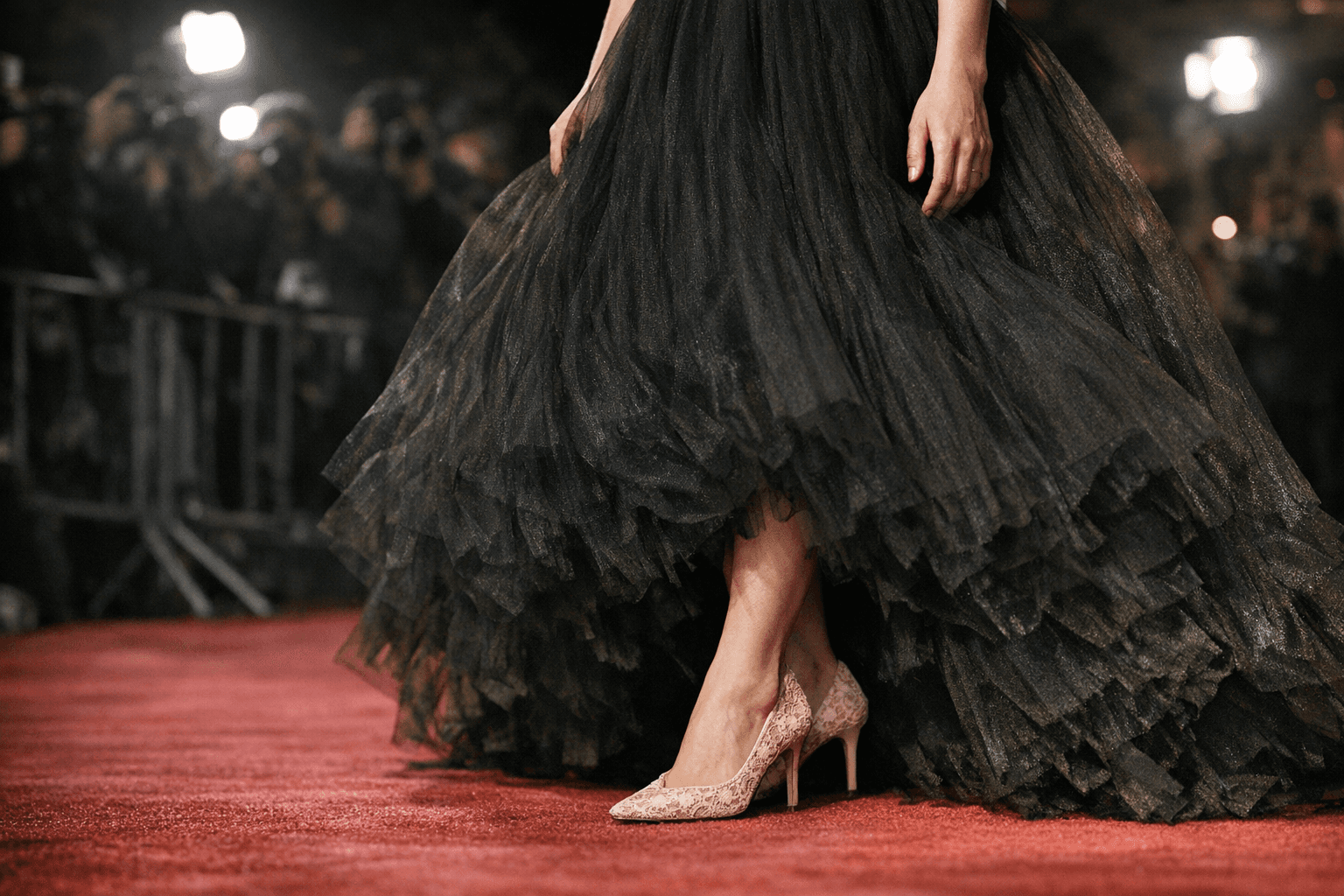 Abby Quinn’s pink lace Jimmy Choo pumps balance her black tulle gown
