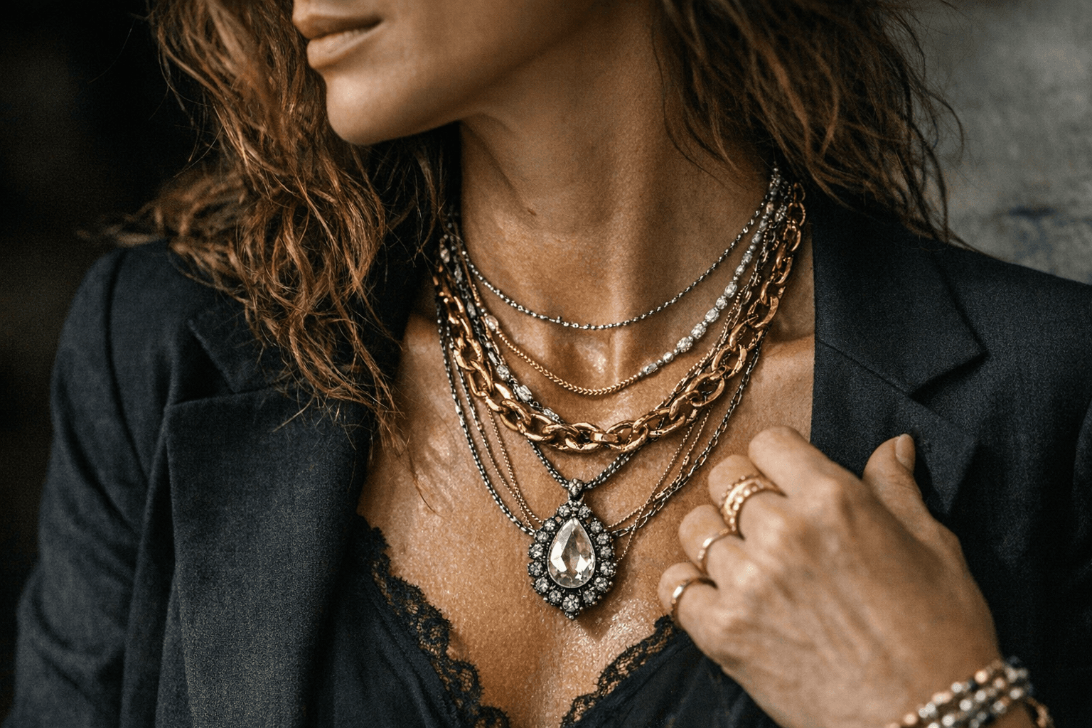 Jewelry layering takes center stage, mixing chains, textures, and focal pieces