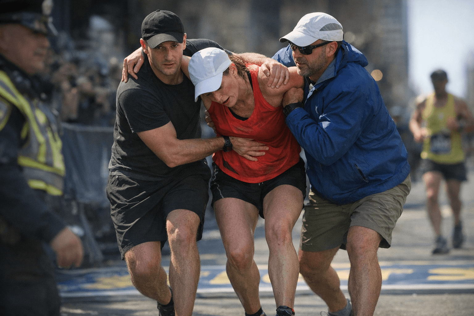 Two strangers help struggling runner cross Boston Marathon finish line