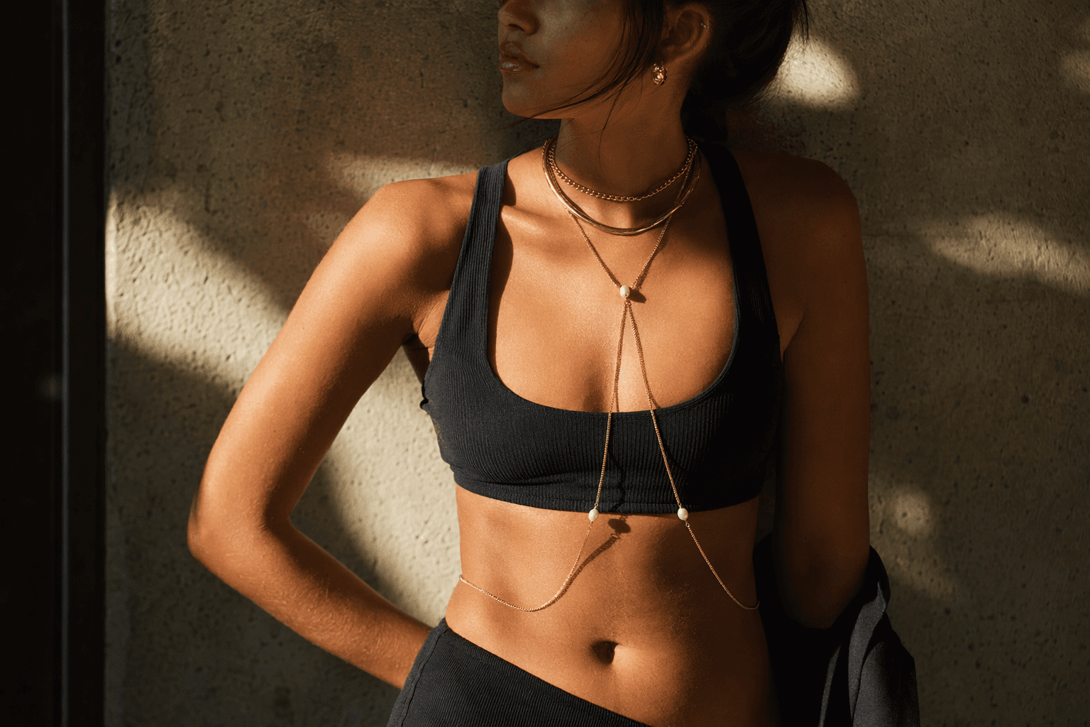 Jewelry layering evolves with body chains, bold metals, and statement textures