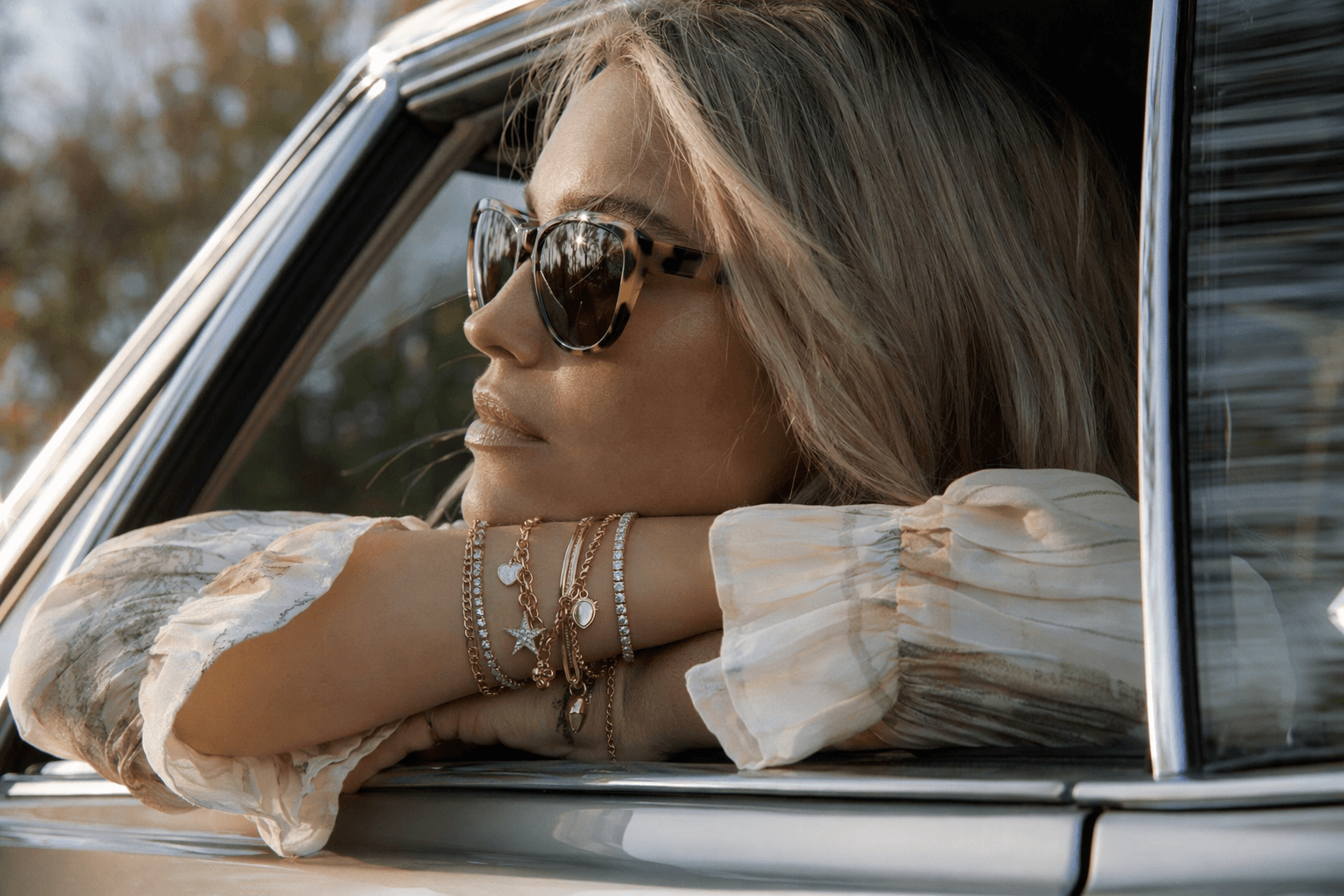 Charm bracelets return as the new base for layered stacks
