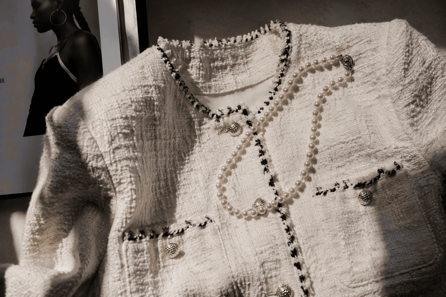 Teyana Taylor styles Chanel tweed with a single-strand pearl necklace