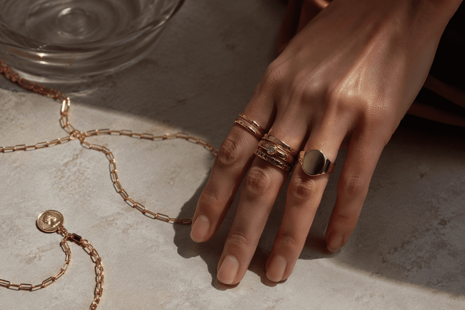 signet rings return as stackable anchors in jewelry layering