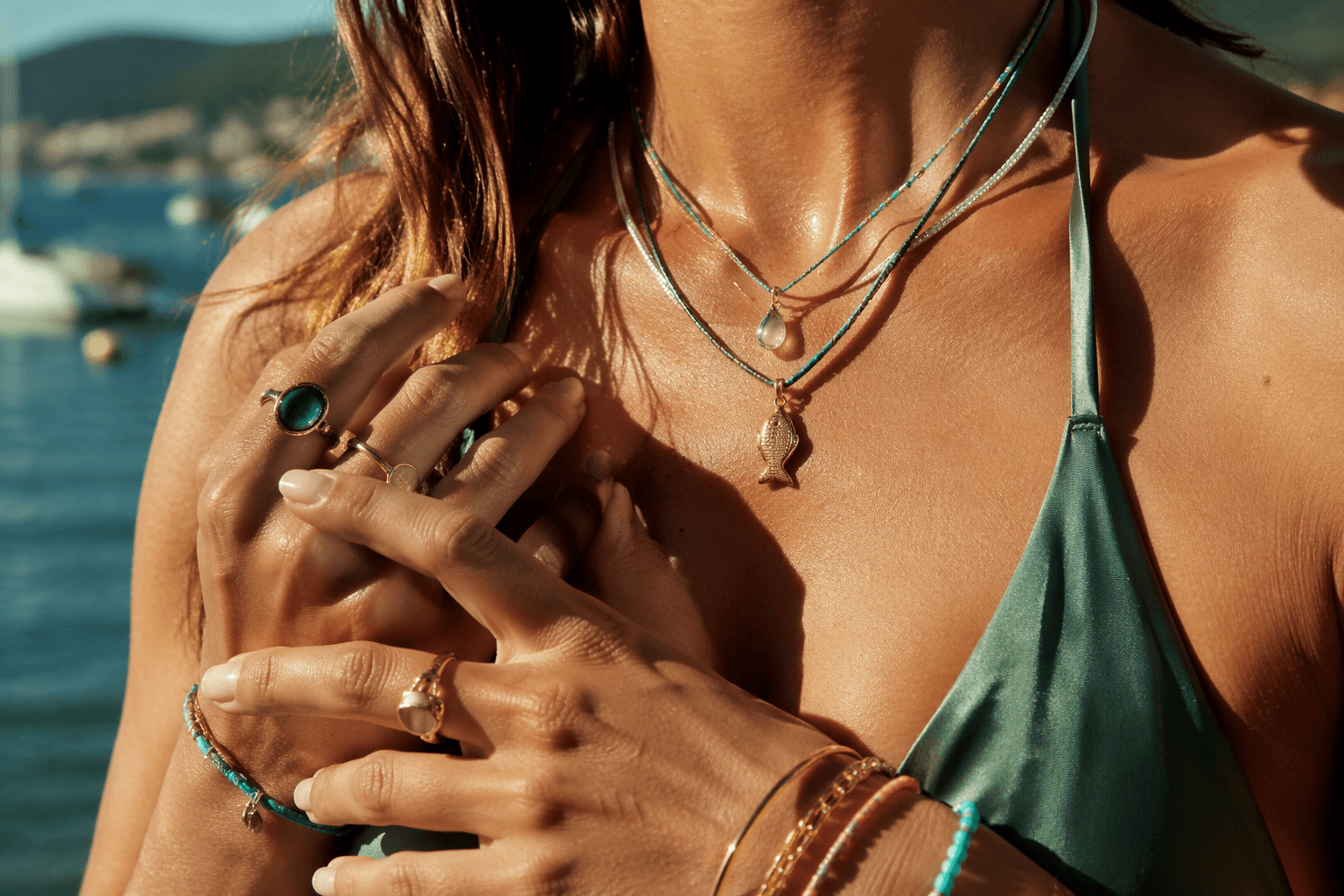 Playful summer jewelry layering leans on color, charms and stacks
