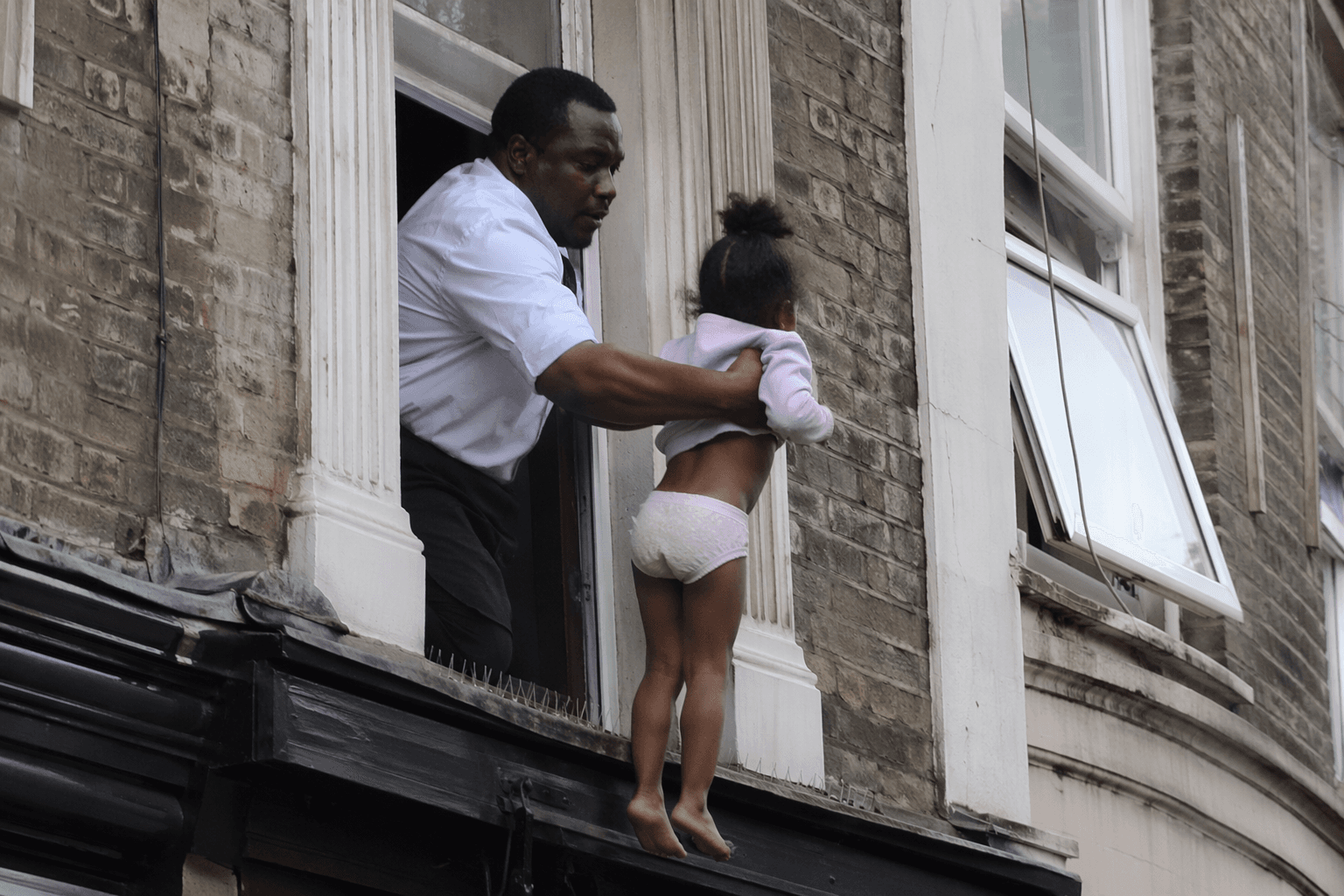 Restaurant manager rescues girl dangling from London balcony ledge