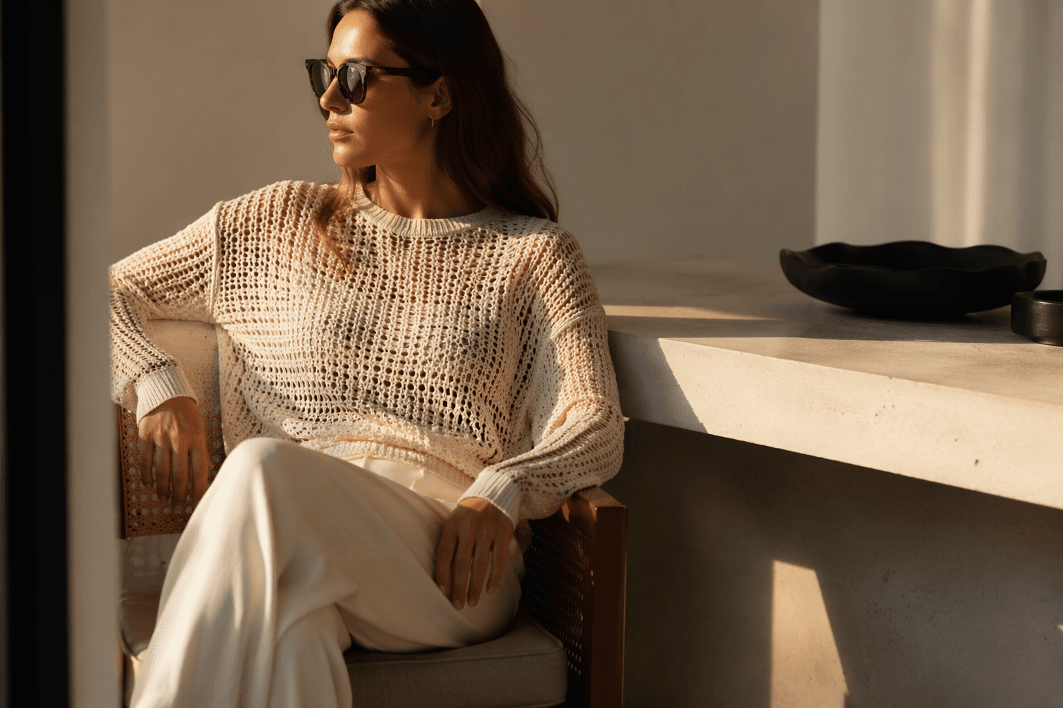 Open-knit sweaters replace button-downs in minimalist summer wardrobes