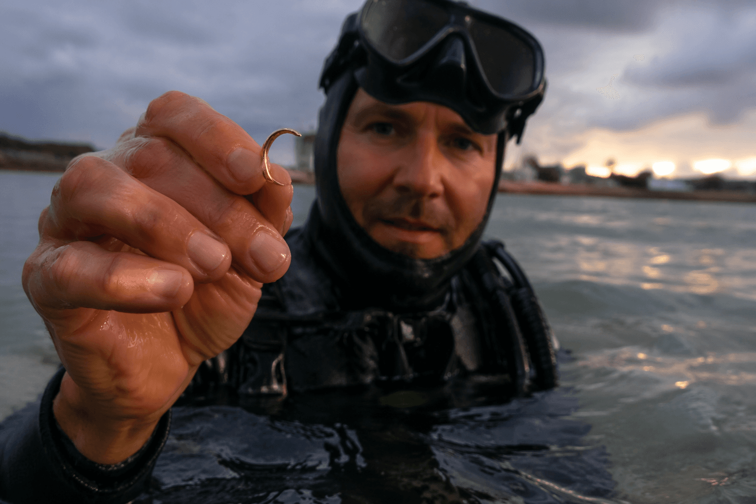 Chest-deep beach hunt yields bent 21K ring after long dry spell