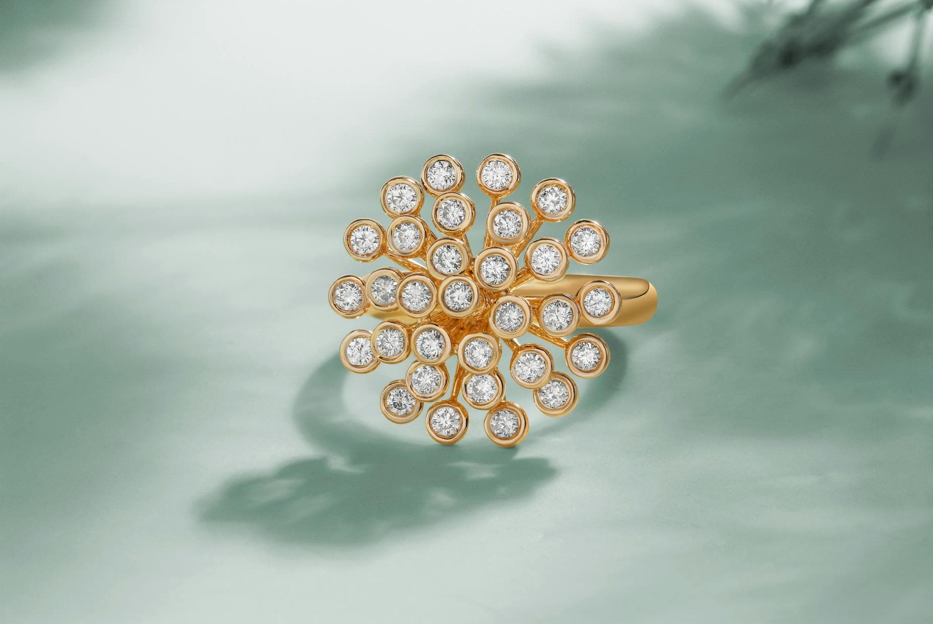 Calms Jewelry’s Ripple ring layers gold around a heptagonal diamond