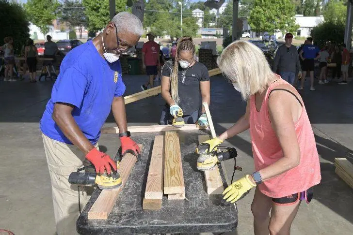 Volunteers build 34 beds for children at Old Armory Pavilion