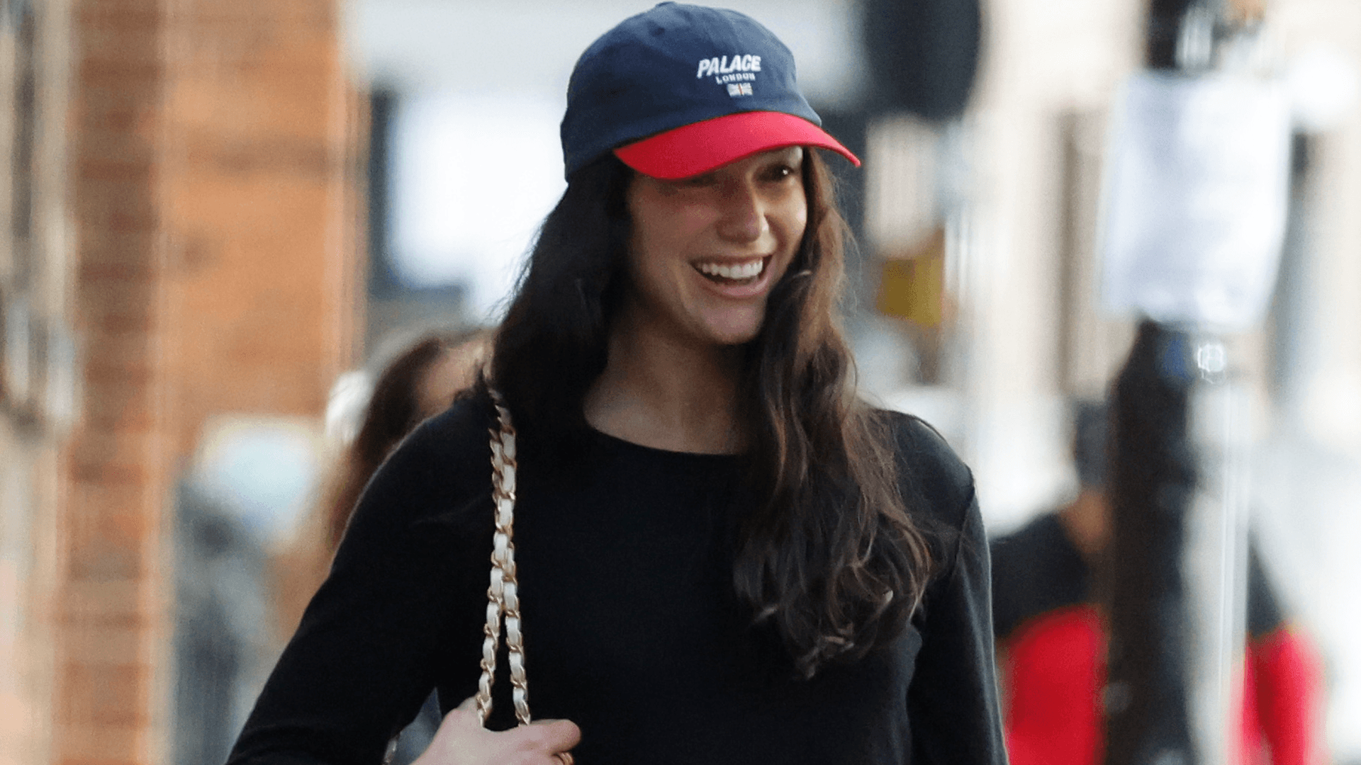 Dua Lipa turns airport white jeans into bridal-weekend chic