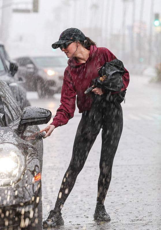 Dakota Johnson Drenched Leaving Studio City Gym in Burgundy Hoodie