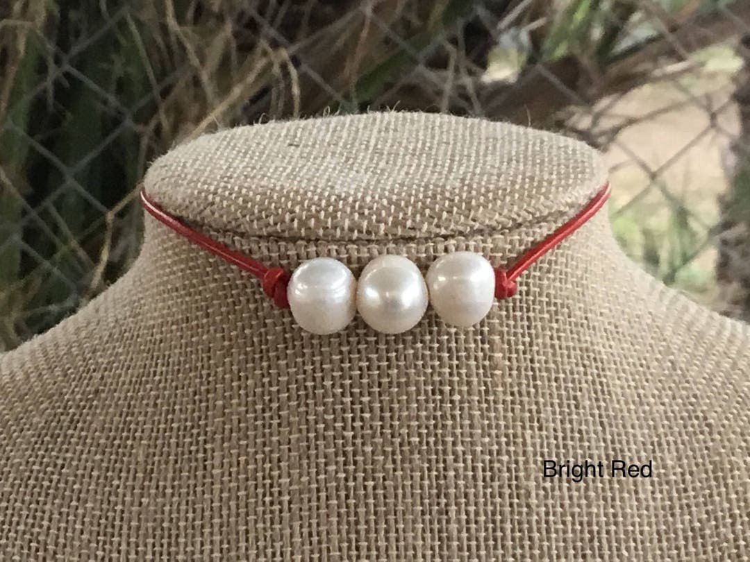 Three freshwater pearls on red leather make an easy summer necklace