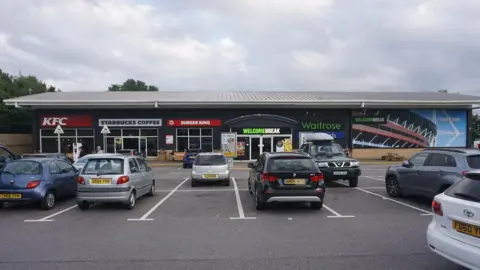 Child among three hurt as car hits shop at Cardiff Gate services