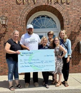 Fergus Falls hands Chris Tungseth $10,985 from community celebration