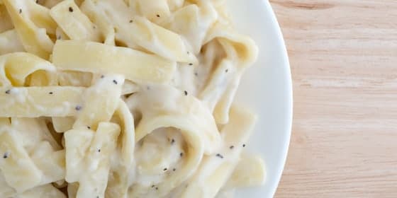 Slate traces how American Italian restaurants introduced cream into Roman fettuccine alfredo