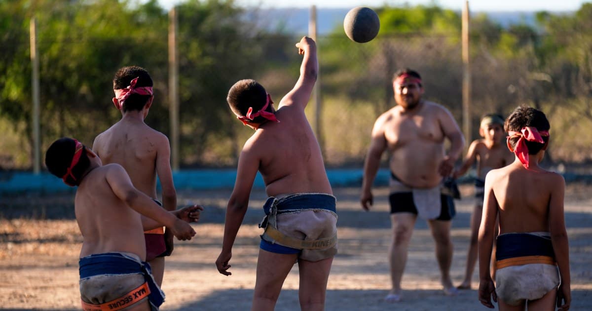 Five cousins on Mexico’s Pacific coast play barefoot on a dirt field