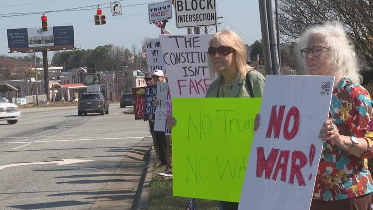 Indivisible Guilford County leads anti-war protest with 30 attendees on Wendover Avenue