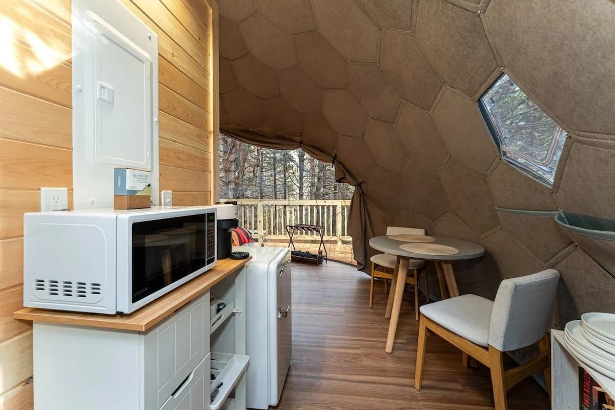 Mirrored Gaia Nook dome blends futuristic style with rustic tiny-house warmth