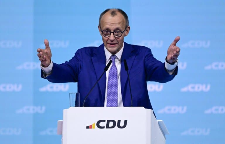 Merz warns Germany must reform fast, jeered by union workers