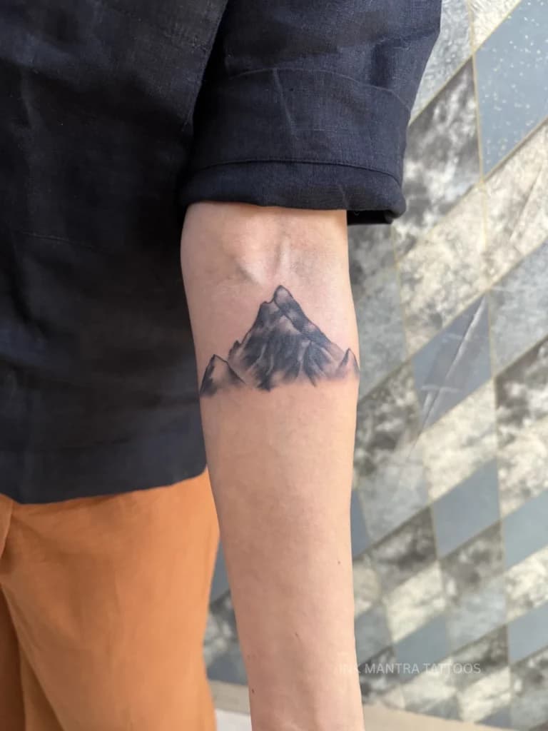 Geometric Mountain Tattoos Capture Endurance, Stability, and Sharp Linework