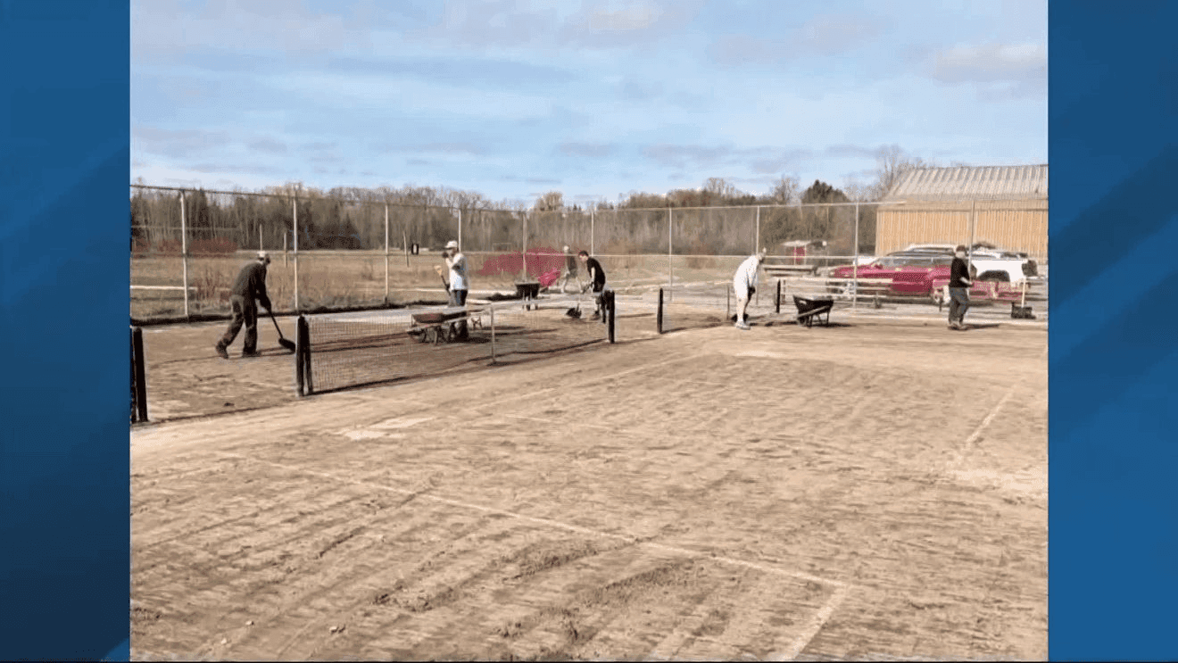 Volunteers clear Boardman River pickleball courts after historic flooding